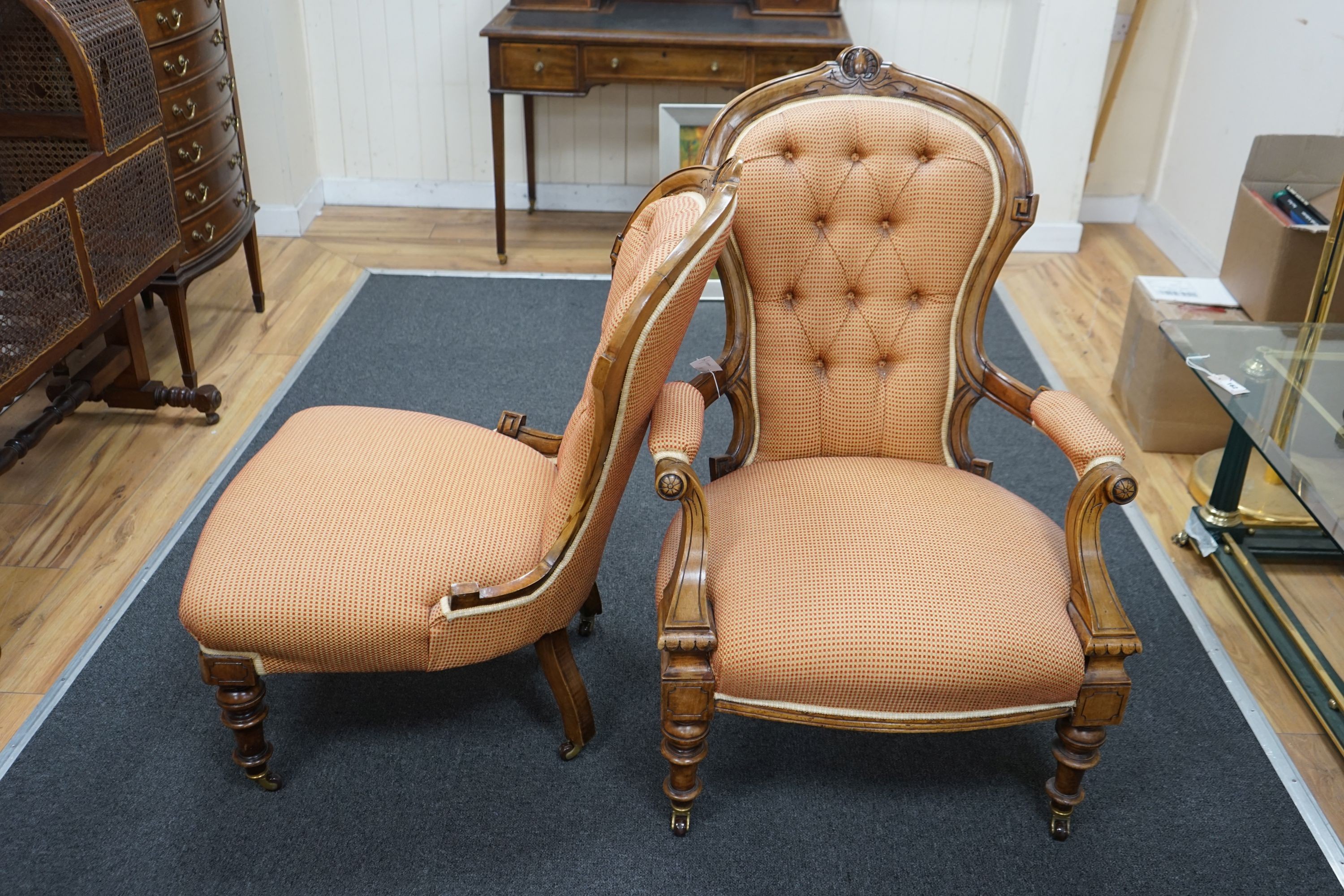A pair of late Victorian walnut spoon back chairs, one with arms, larger width 68cm, depth 60cm, height 100cm